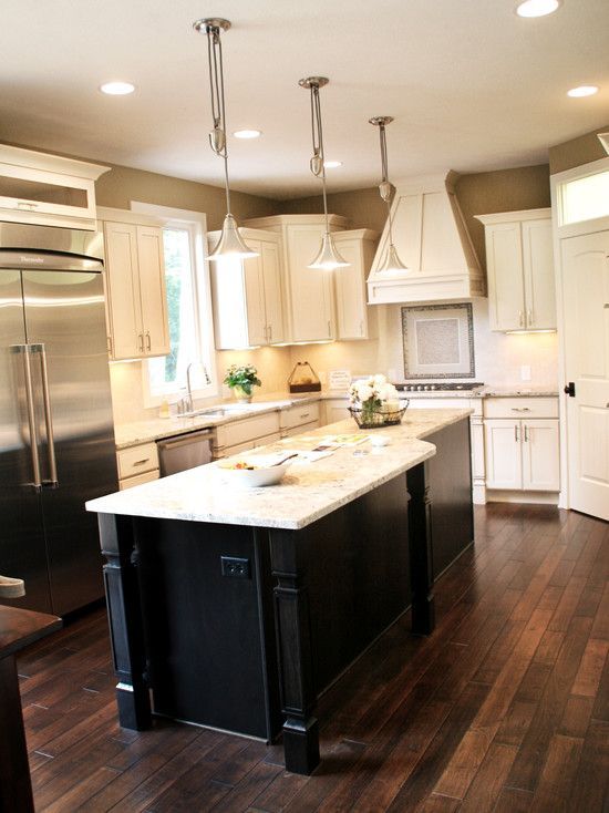 Dark Wood Floors with cream cabinets and dark island | Kitchen
