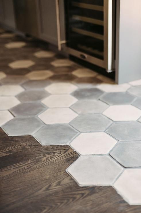 Fantastic gray kitchen features a white and gray hex concrete tiled