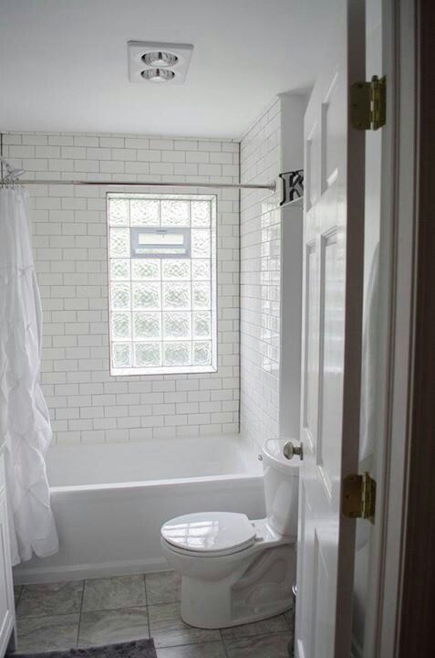 We remodeled! White subway tile, gray grout, glass block window