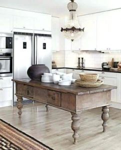 Modern white kitchen with antique rustic wood island. french country