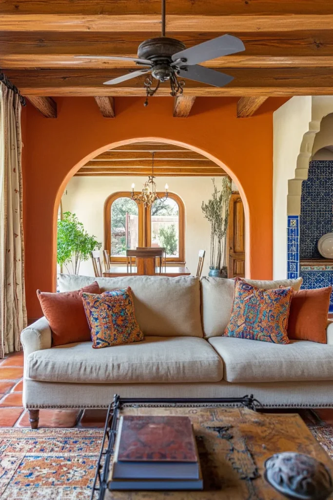 Warm earth-toned living room featuring Moroccan tiles, ornate lantern, and vibrant textiles in Spanish Mediterranean style