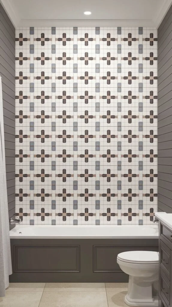 Graphic luxury shower accent wall covered in small mosaic tiles forming a continuous repeating pattern of crosses or plus symbols in earthy and cool neutral colors.