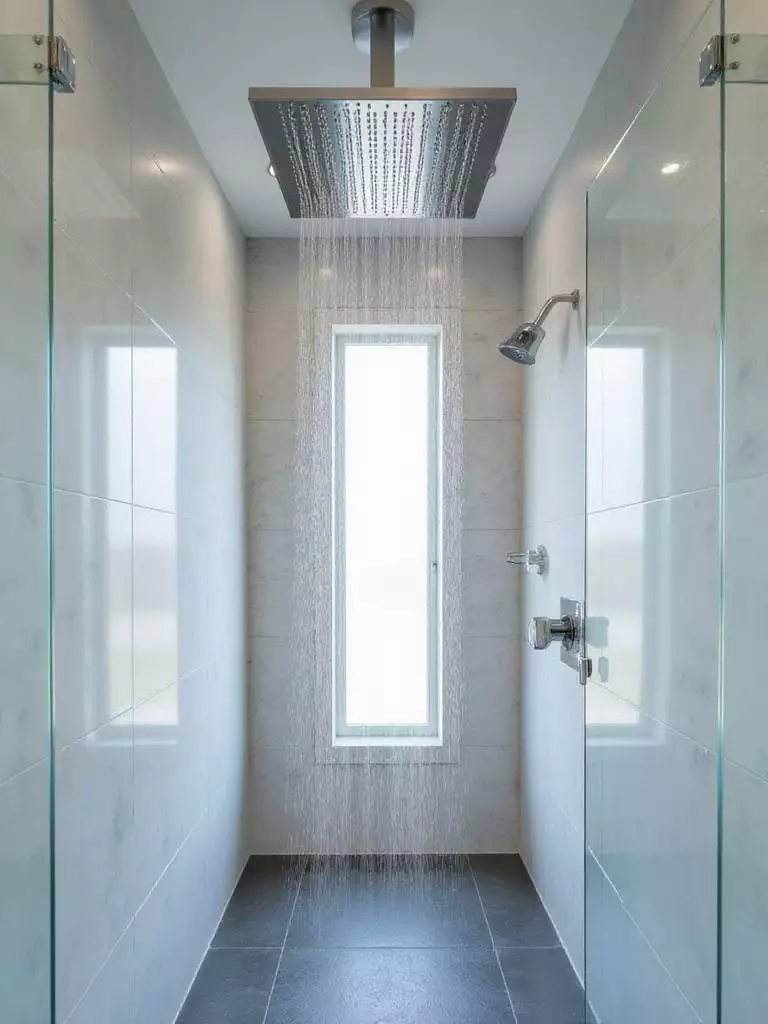 Luxurious bathroom featuring a large, square rainfall showerhead providing a spa-like shower experience.