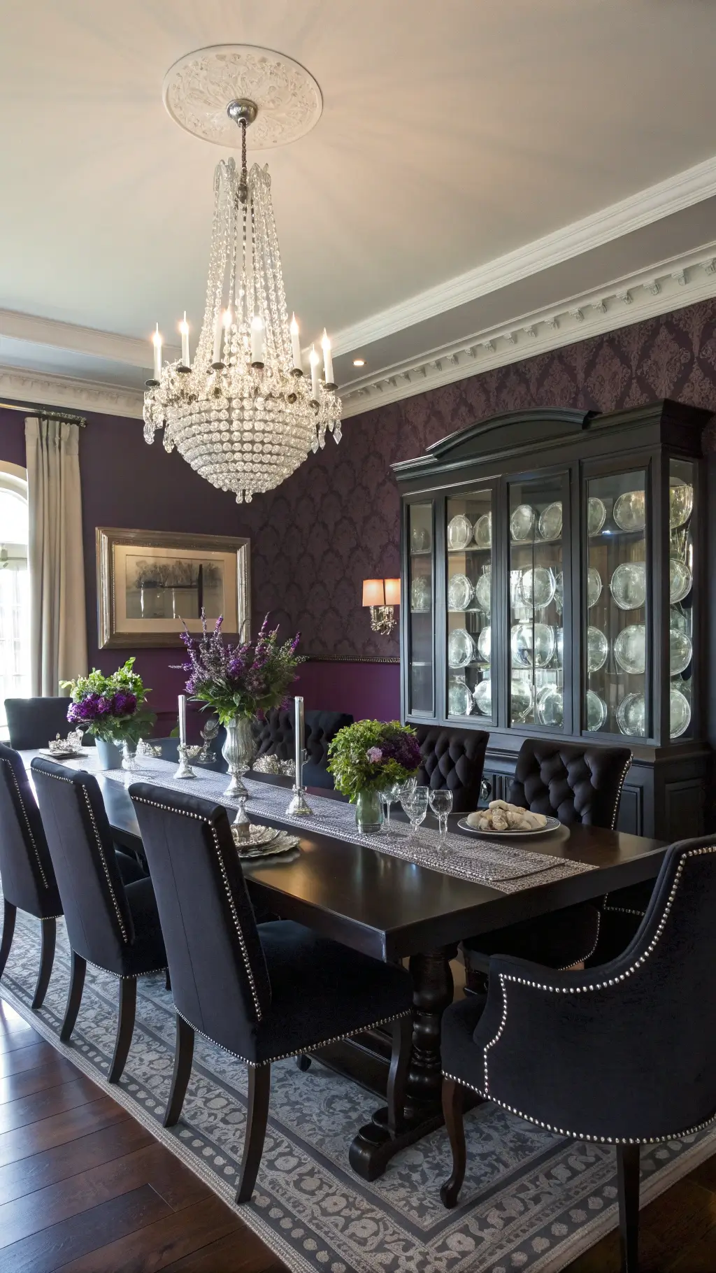 Elegant dining room with dark plum walls and crystal chandelier