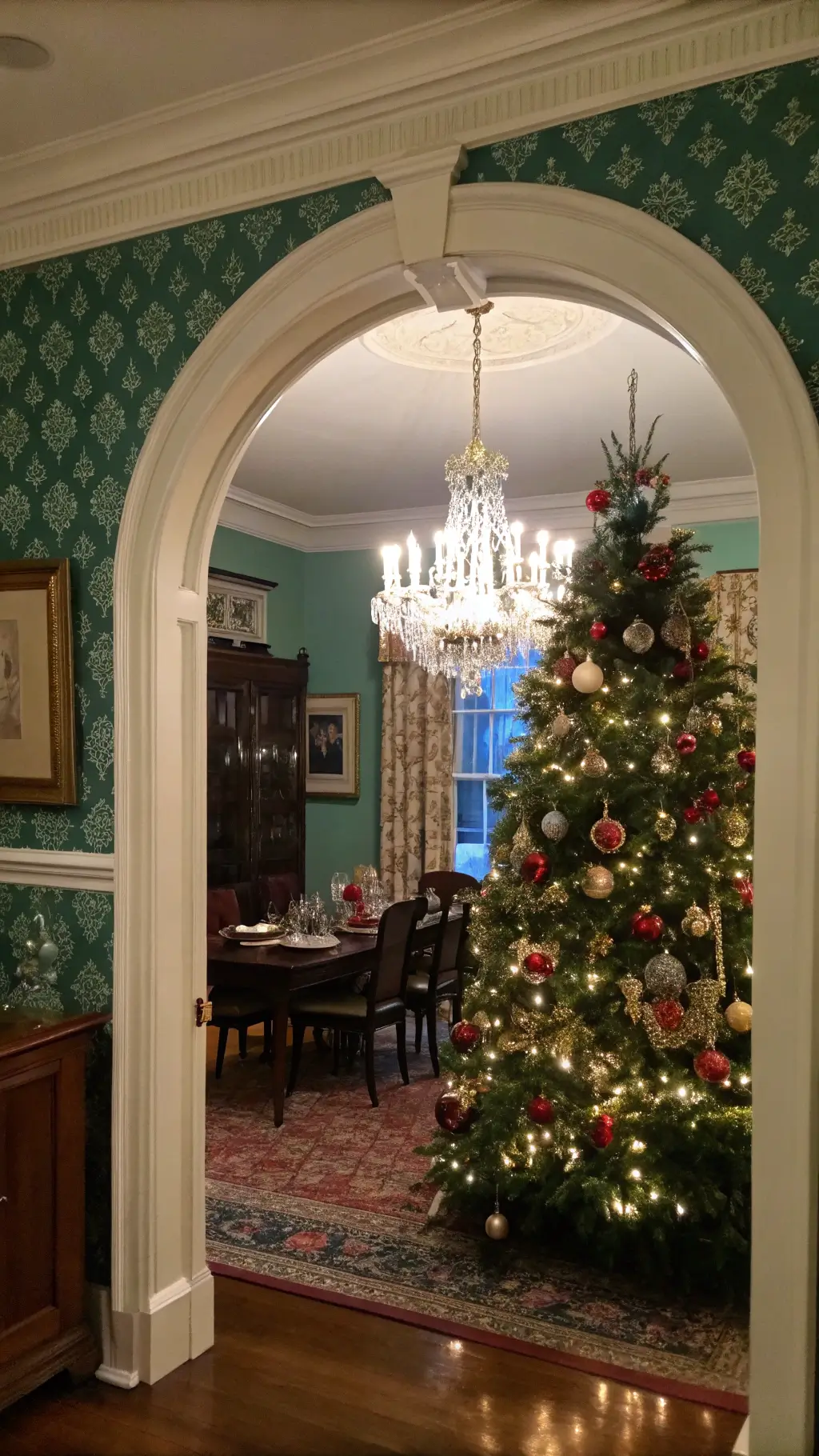 Traditional dining room at twilight with a holiday tree decorated with heirloom and personalized photo ornaments.