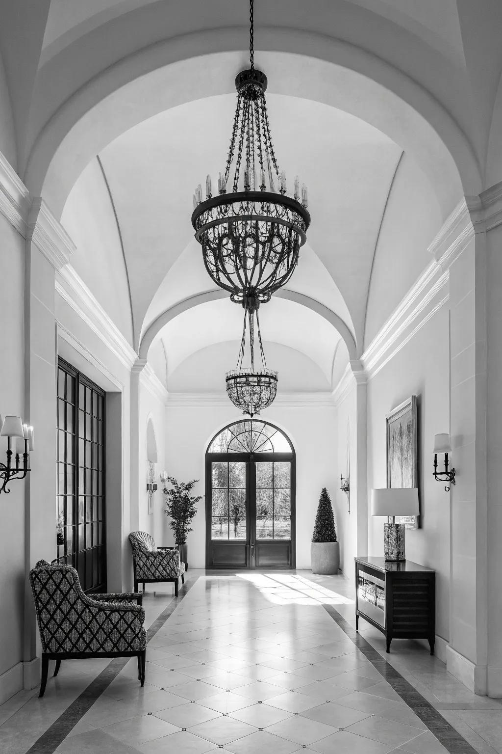 A monochrome chandelier adds sleek sophistication to this modern foyer.