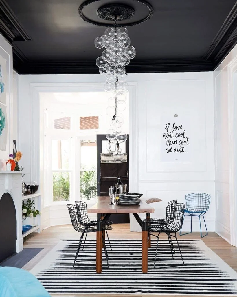 Black painted ceiling with bubble chandelier