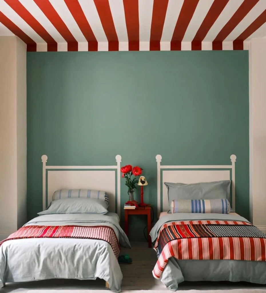 Red and white striped ceiling in bedroom